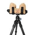 Tan shooting rest bag strapped to an Arca shooting plate on a carbon fibre tripod